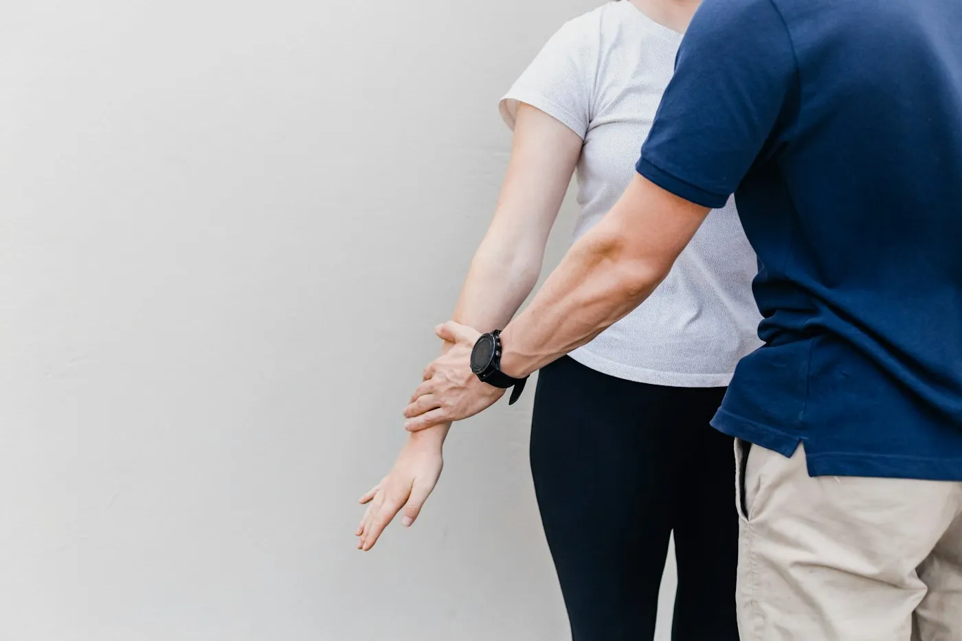 A chiropractor checking a patient's shoulder