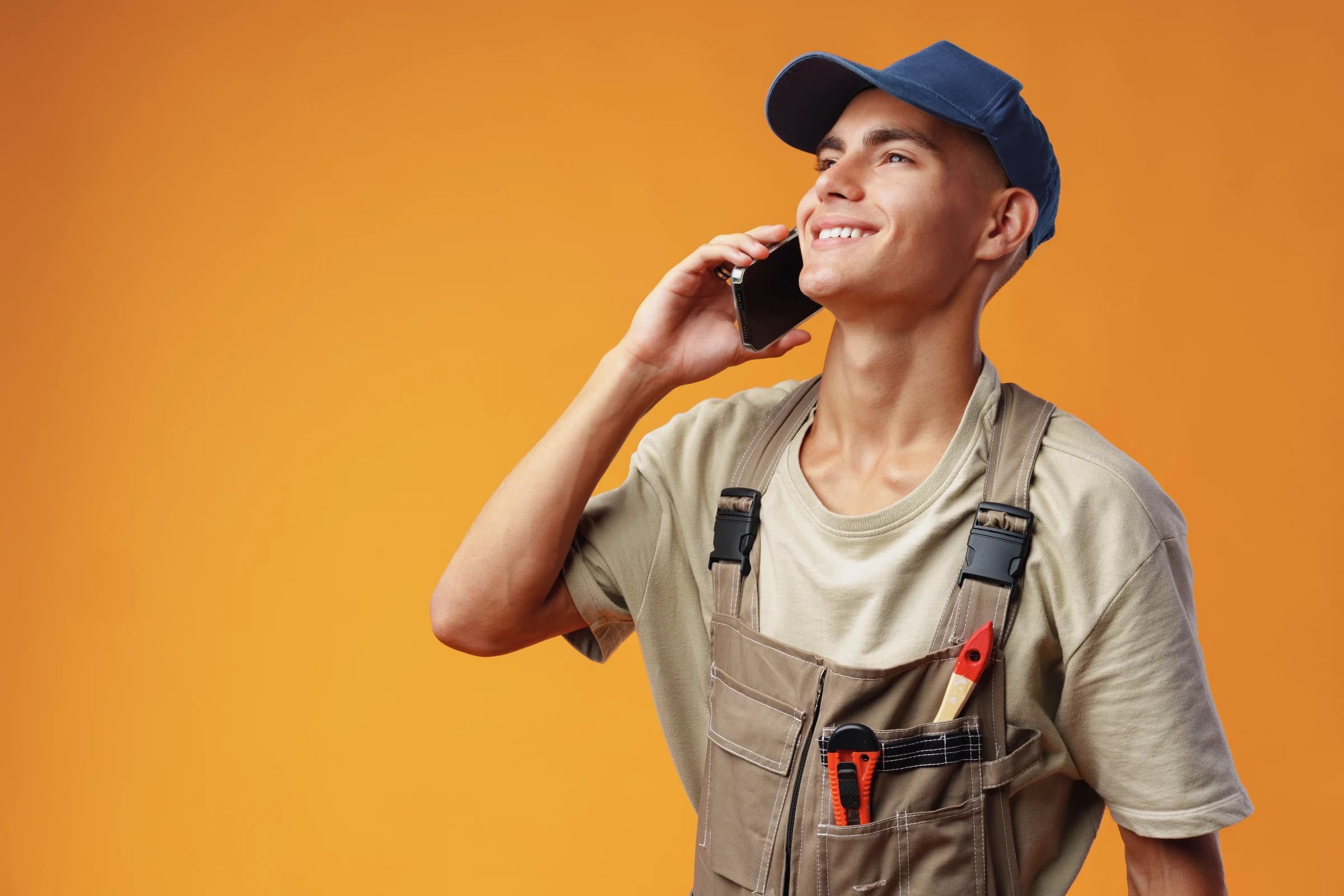 A tradesperson taking a call on their business number