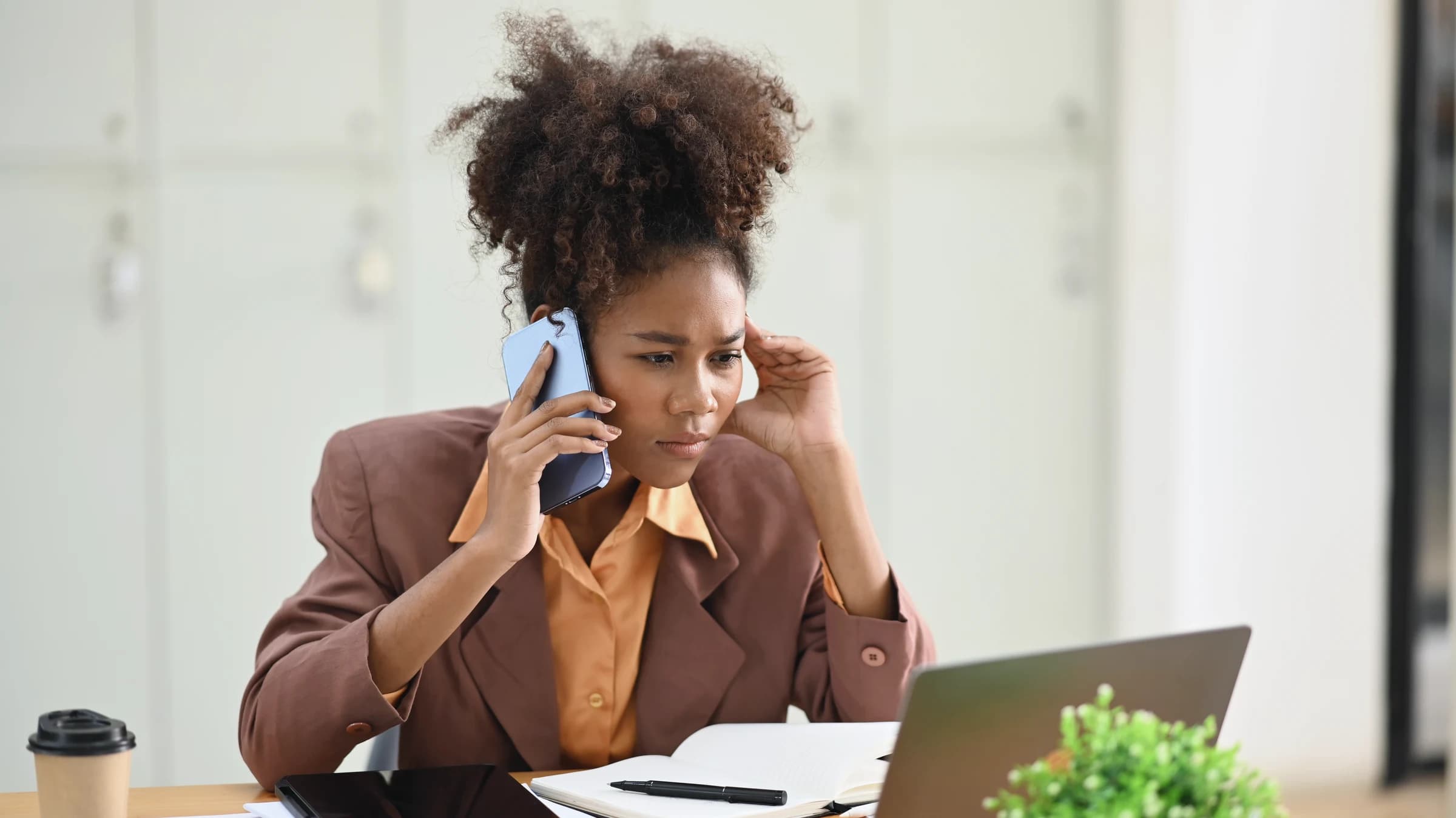 A woman speaking on the phone with a focused expression