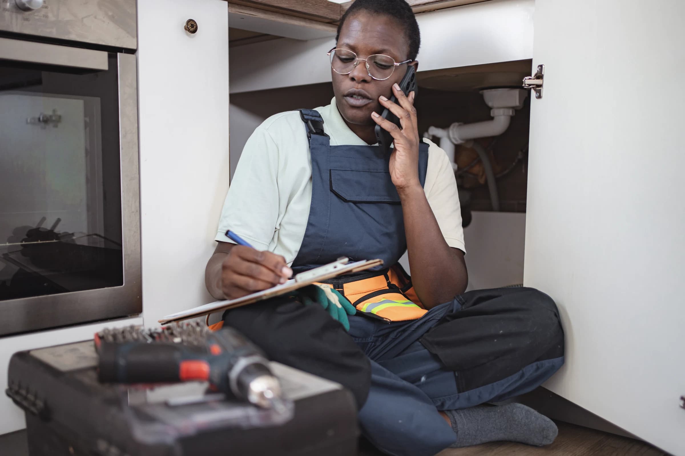 A worker taking notes during a phone call on a job